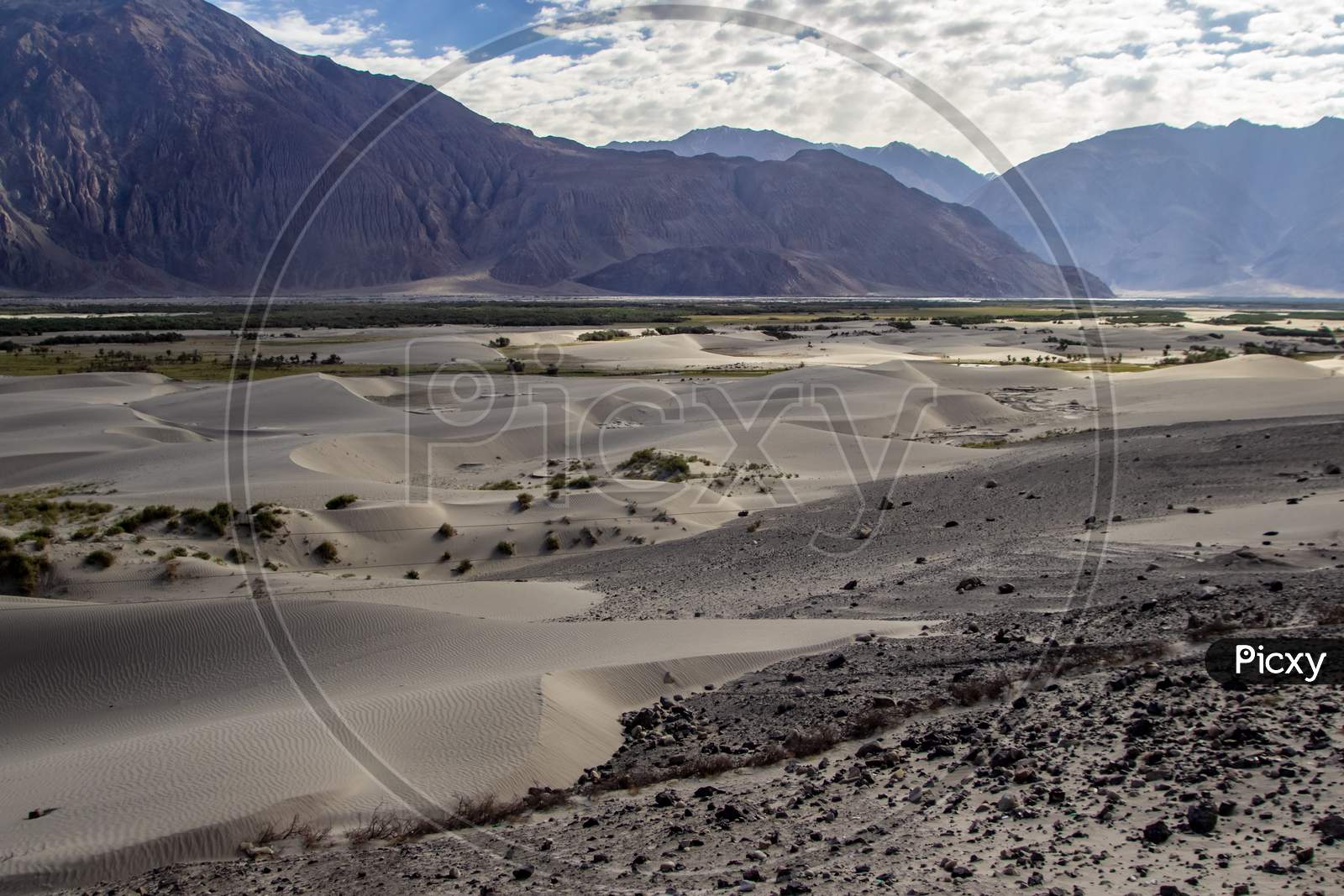 Arid Dry Dessert Sand Dunes Of Nubra Valley With Himalayan Barren Mountain Range In The Background At Ladakh, Kashmir, India