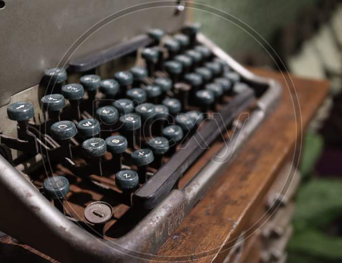 A Closeup Image Of An Old Vintage Type Writer With Eroded Keys With Selective Focus On A S D W Keys And Background Blur