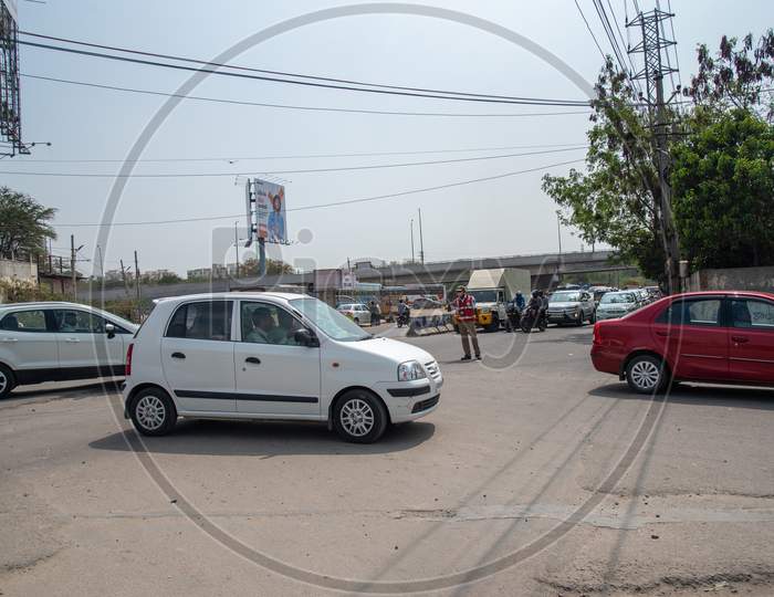Traffic Police guiding traffic into railway underpass at the Hitech City MMTS station