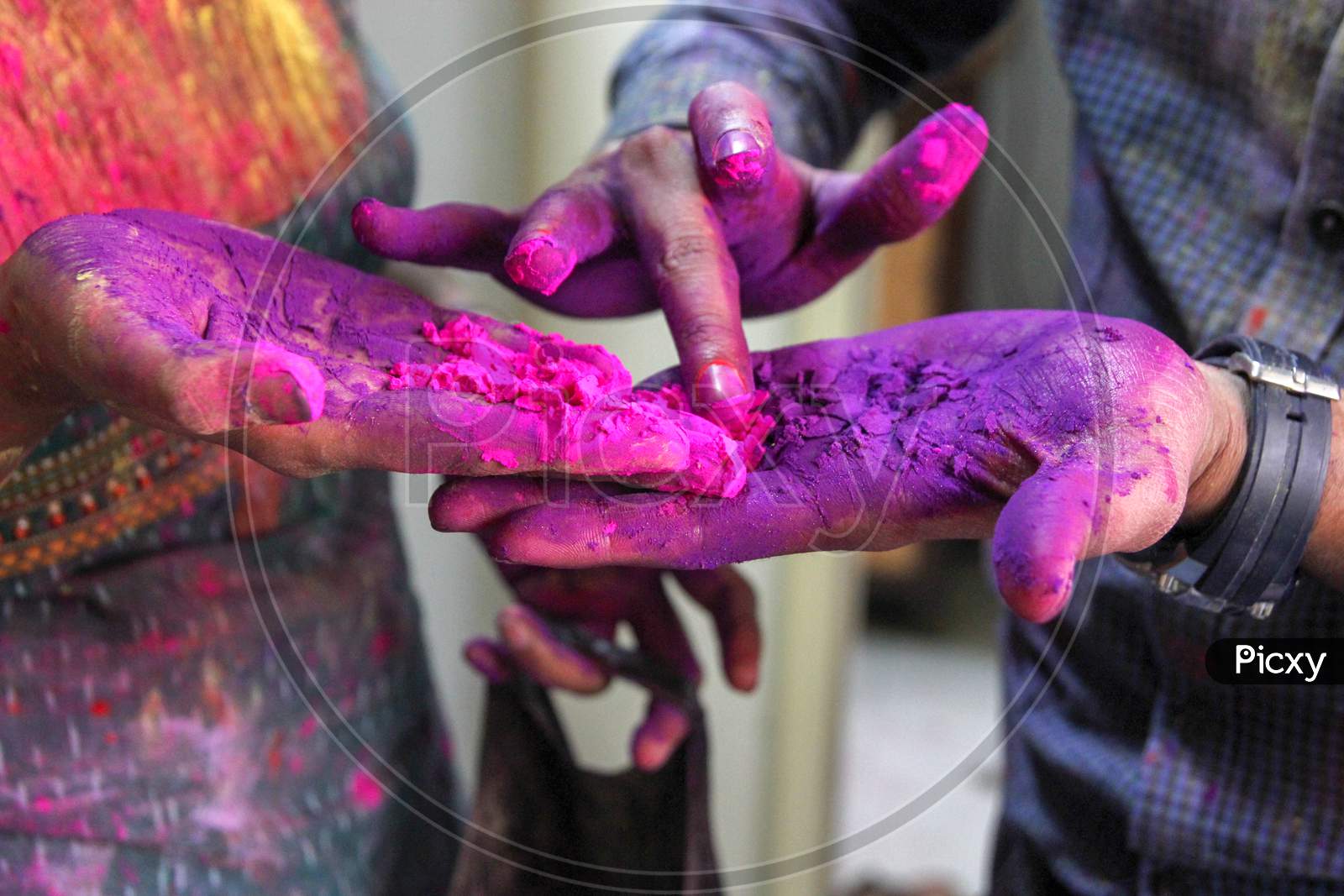 Closeup Photo Of 3 Hands With Holi Colors Mixing The Colors With Finger. Holi Festival Concept Image.
