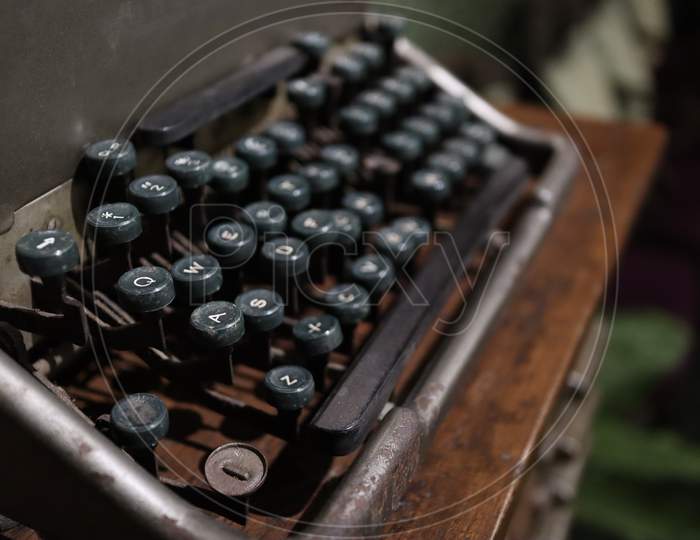 A Closeup Image Of An Old Vintage Type Writer With Eroded Keys With Selective Focus On A S D W Keys And Background Blur