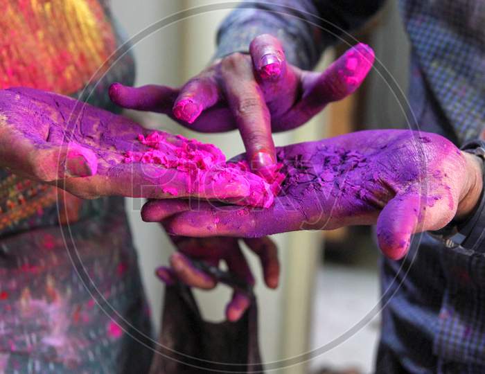 Closeup Photo Of 3 Hands With Holi Colors Mixing The Colors With Finger. Holi Festival Concept Image.