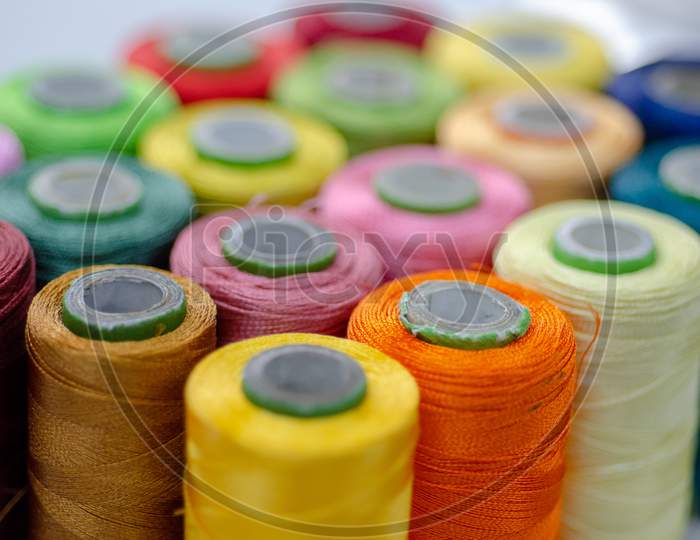 Set Of Colourful Sewing Threads  or Reels or thread spools used in fabric and textile industry