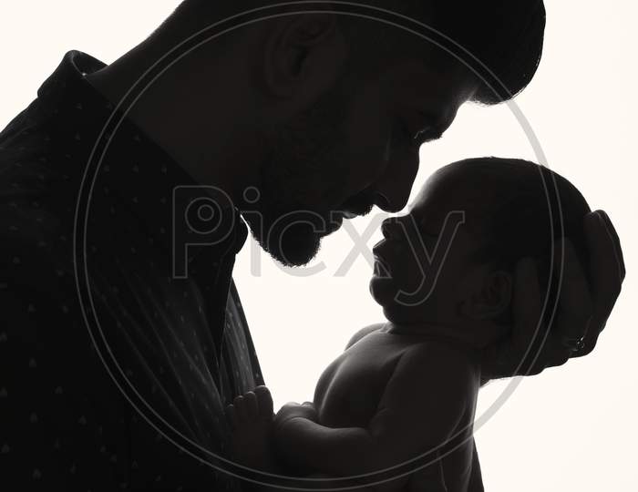 Silhouette of A Father Holding His Child