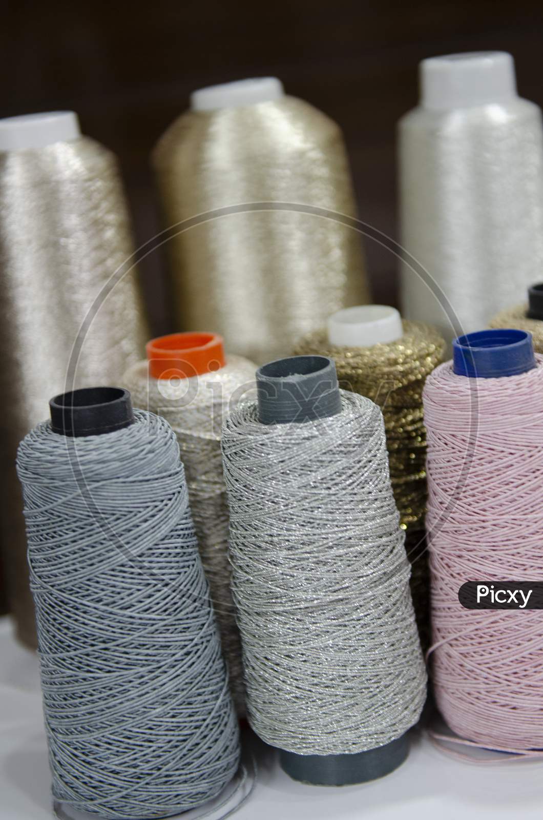 Set Of Colourful Sewing Threads  or Reels or thread spools used in fabric and textile industry