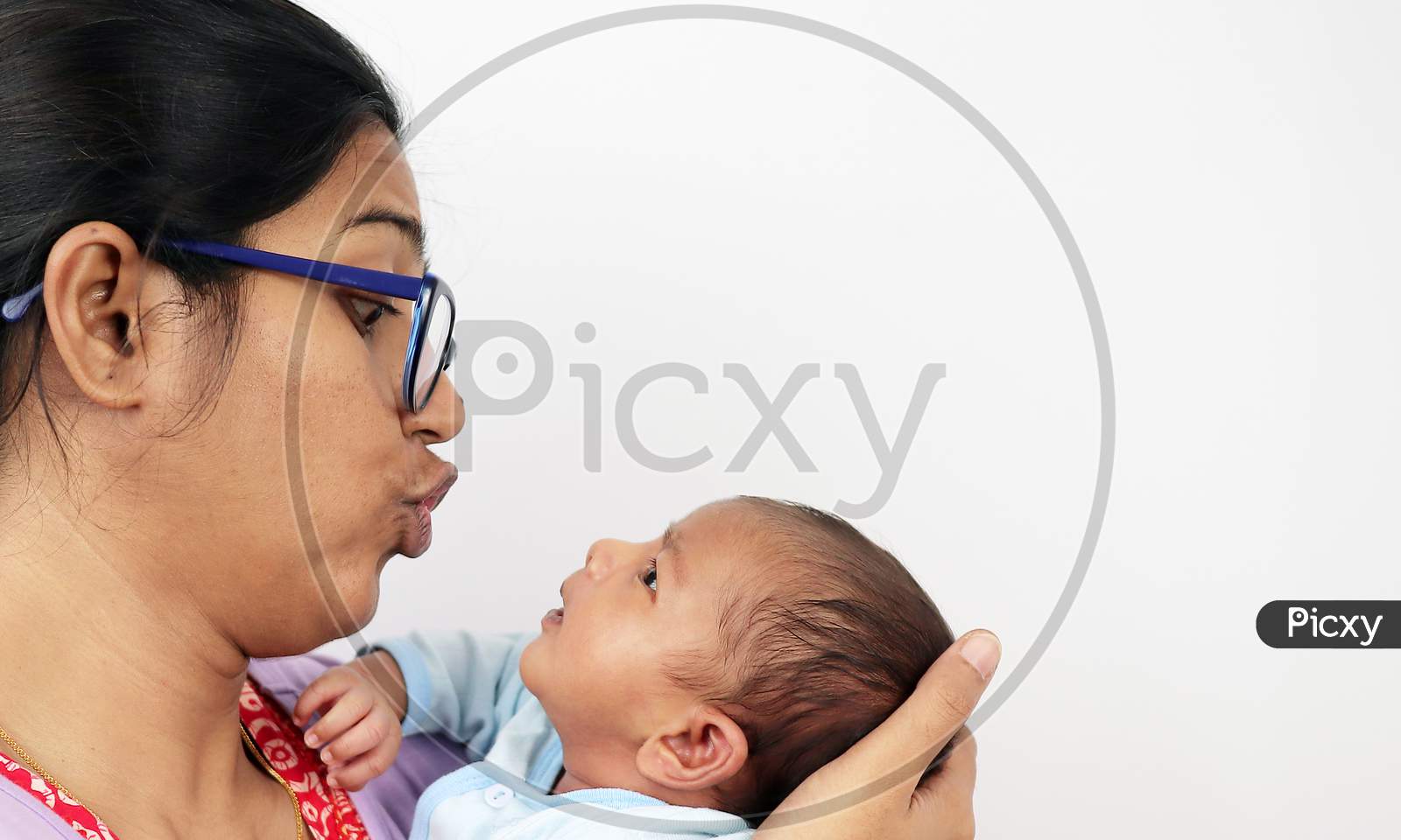 A Mother Making Funny Face At Her Baby Isolated In White Background With Space For Text.