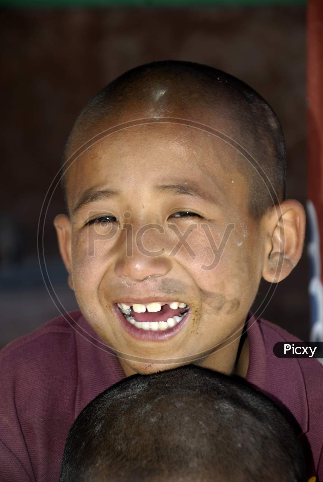 Portrait of a Buddhist Monk Boy With Smile Face