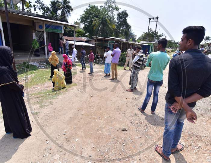 People Standing At Safe Distances In A Queue Wait To Collect Money Outside Atm During The Nationwide Lockdown Imposed In Wake Of Coronavirus Pandemic At Samaguri In Nagaon District Of Assam On April 10,2020.