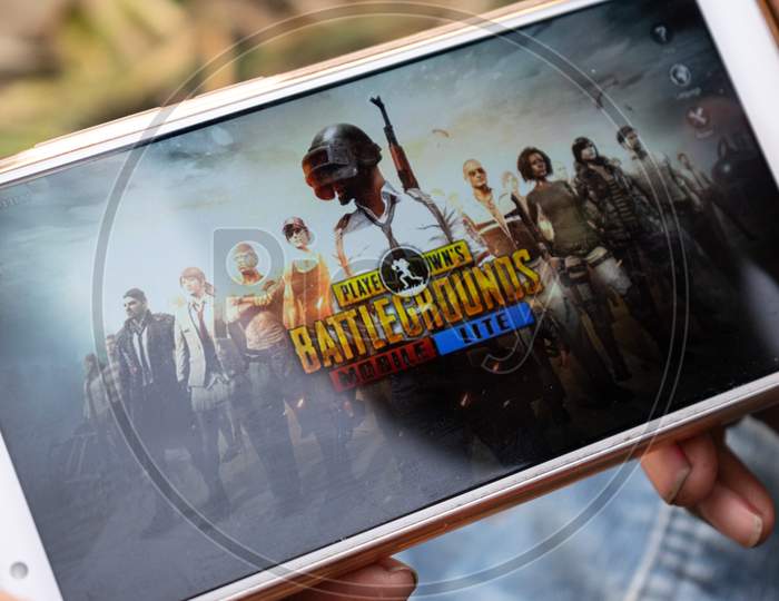 A boy playing PUBG game in a mobile