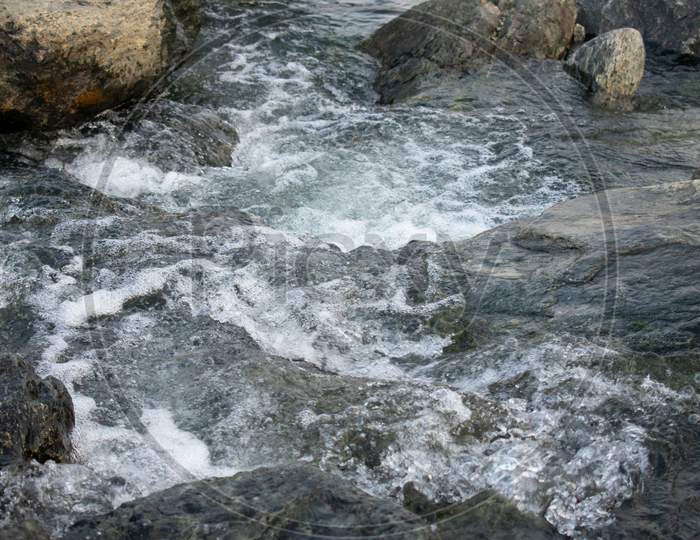 Water Flowing Downhill Through The Rocks