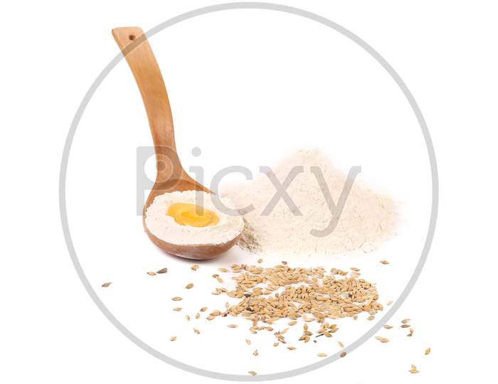 Egg Yolk In Spoon With Flour. Isolated On A White Background.
