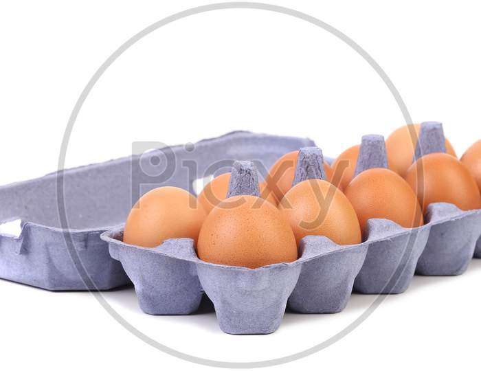Ten Eggs In A Blue Carton Box. Isolated On A White Background.