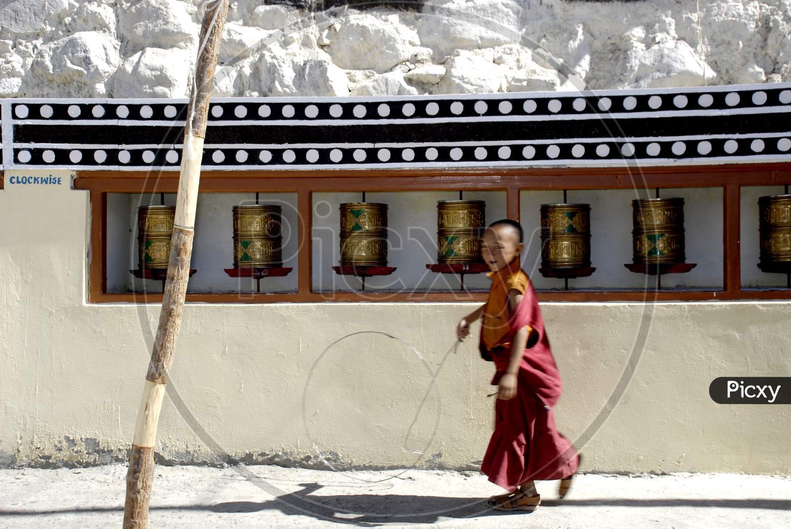 Buddhist Monk Boy Playing At a Buddhist Monastery