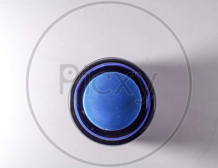 Top View Of A Blue Ink Bottle Against White Background
