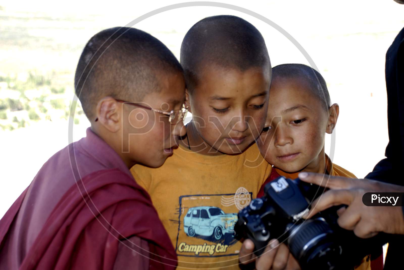 Buddhist Monk Boys Looking at a DSLR Camera