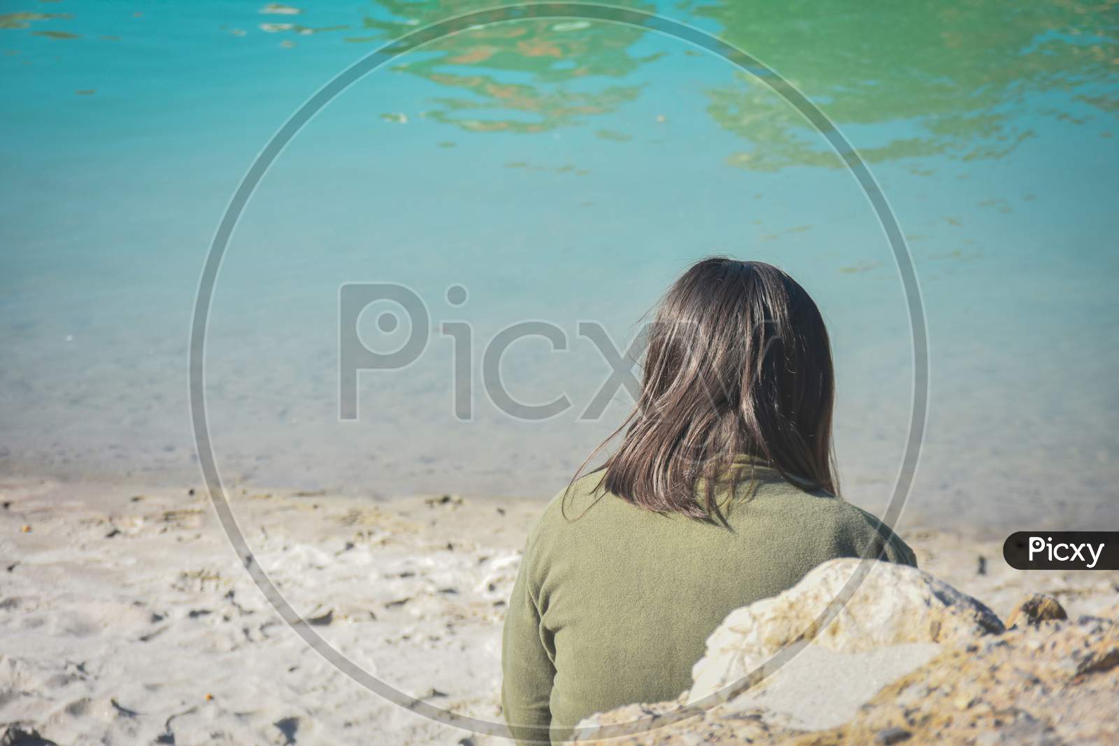 lonely woman sitting on the beach