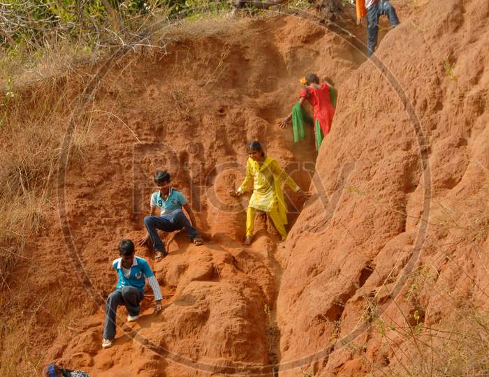 Indian Rural Village Children Climbing Sand Dunes At a River Bank