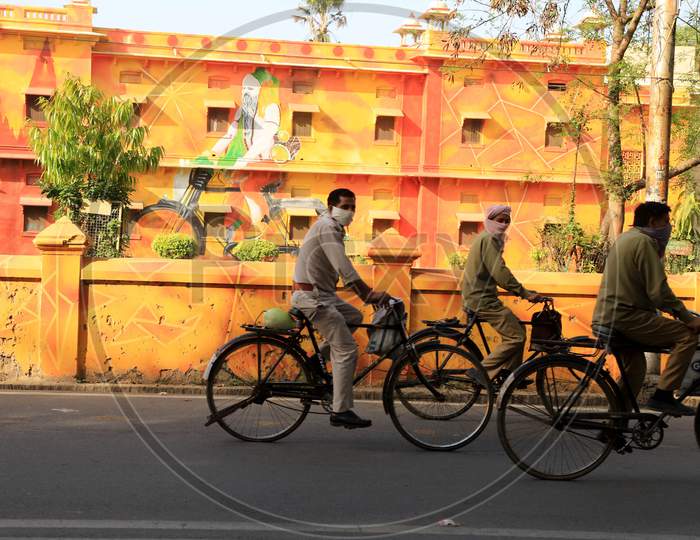 Men Wear Mask Cycling On The Empty Road During Nationwide Lockdown In Wake Of Coronavirus Pandemic In Prayagraj, March 10, 2020.