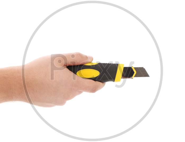 Hand Holds Yellow Stationery Knife. Isolated On White Background.