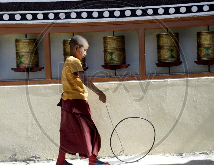 Buddhist Monk Boy Playing At a Buddhist Monastery