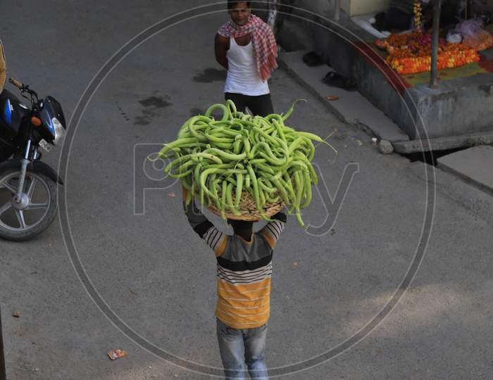 A Farmer Carries Cucumbers Basket From His Field During Nationwide Lockdown In Wake Of Coronavirus Pandemic In Prayagraj, March 10, 2020.