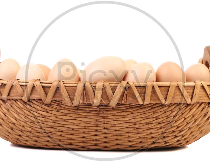 Brown Eggs In The Basket On A White. Isolated On A White Background.