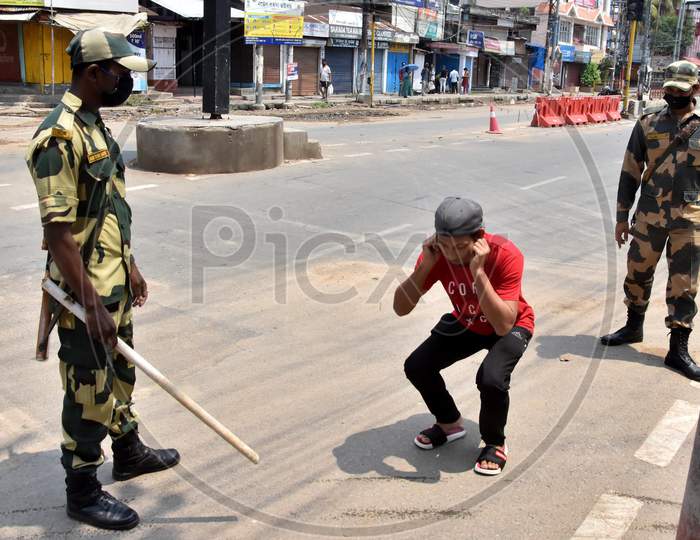 Guwahati - Security Personnel Punishes A Youth For Allegedly Flouting Lockdown, Imposed In The Wake Of Coronavirus Pandemic, In Guwahati Friday, April 10, 2020.