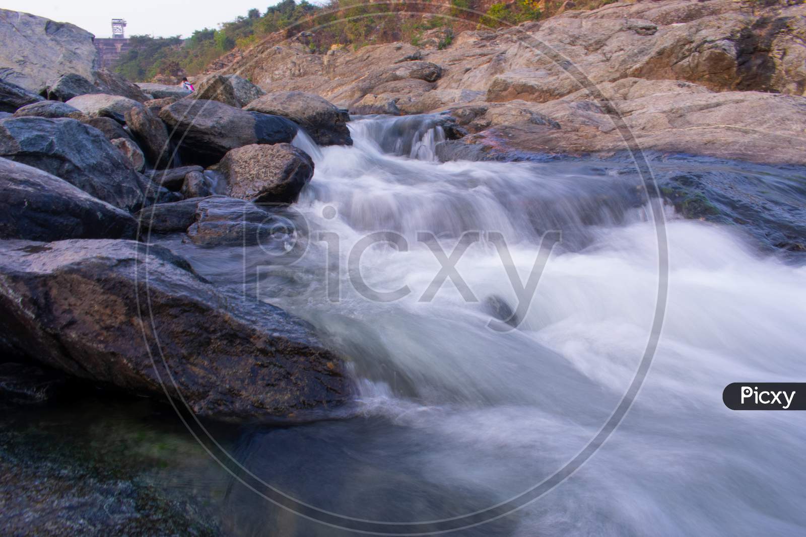 Long Exposure Image Of Flowing Water Downhill Through The Hill