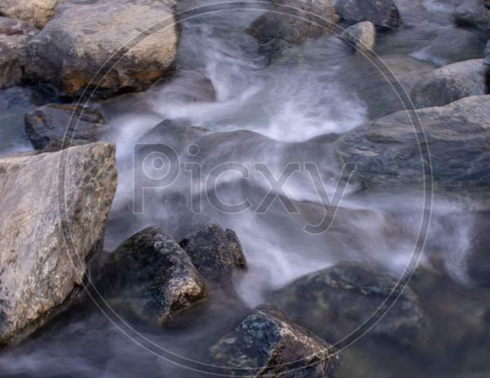 High Exposure Image Of Water Flowing Down Between The Rocks