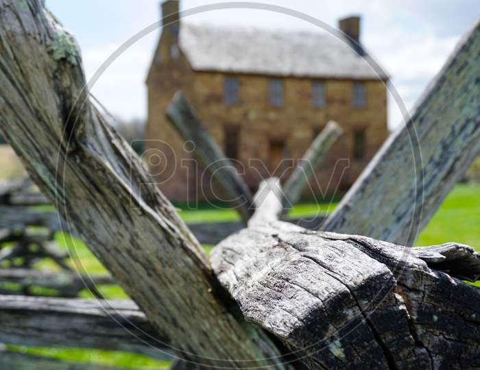 Focused view through fence to civil war house