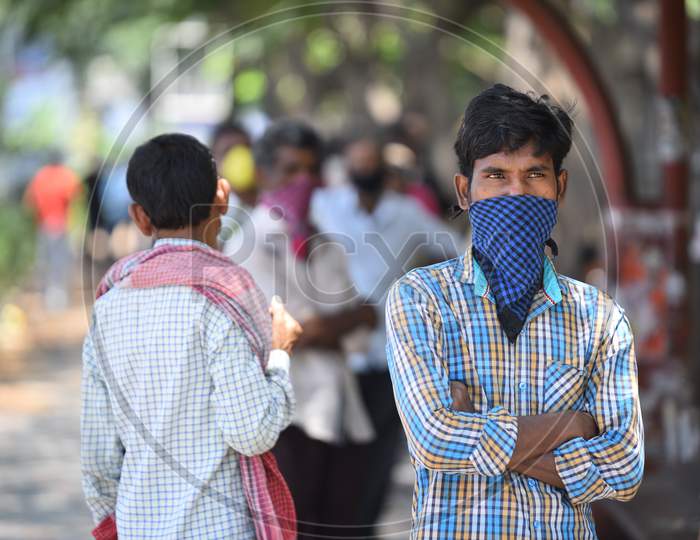 Migrant workers wait for their turn at a free food serving GHMC Annapurna Counter in Madhapur amid nationwide lockdown due to coronavirus pandemic, April 10,2020, Covid 19