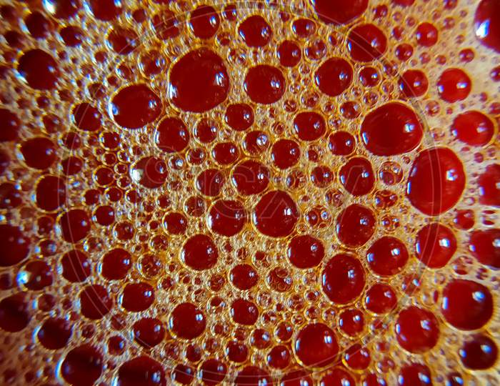 Photo of red colour bubbles on water surface. Design of water bubbles on water surface.