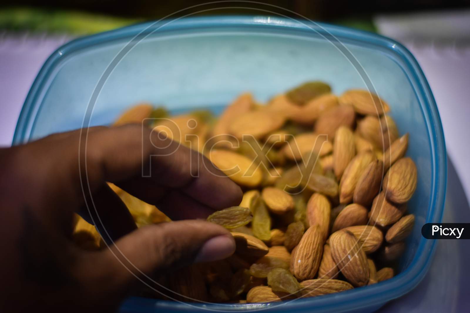 boy eating almonds and almonds on a bowl