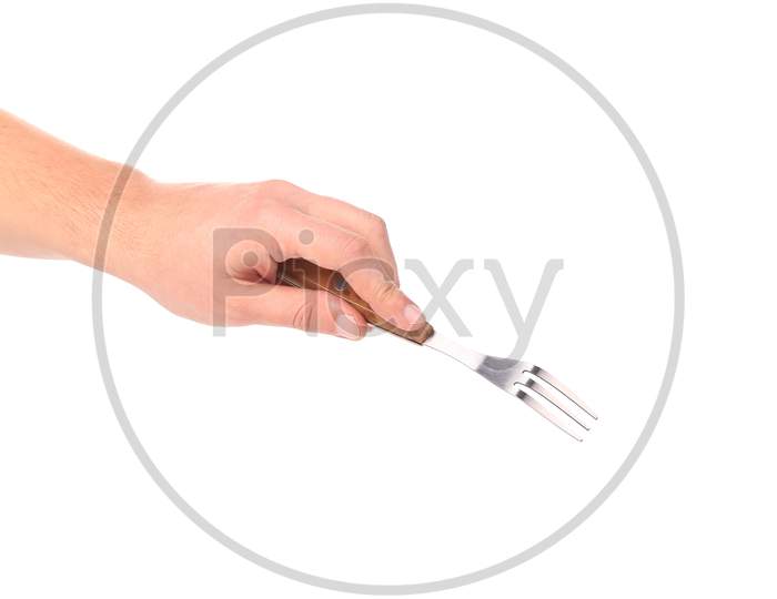 Close Up Of Kitchen Fork In Hand. Isolated On A White Background.