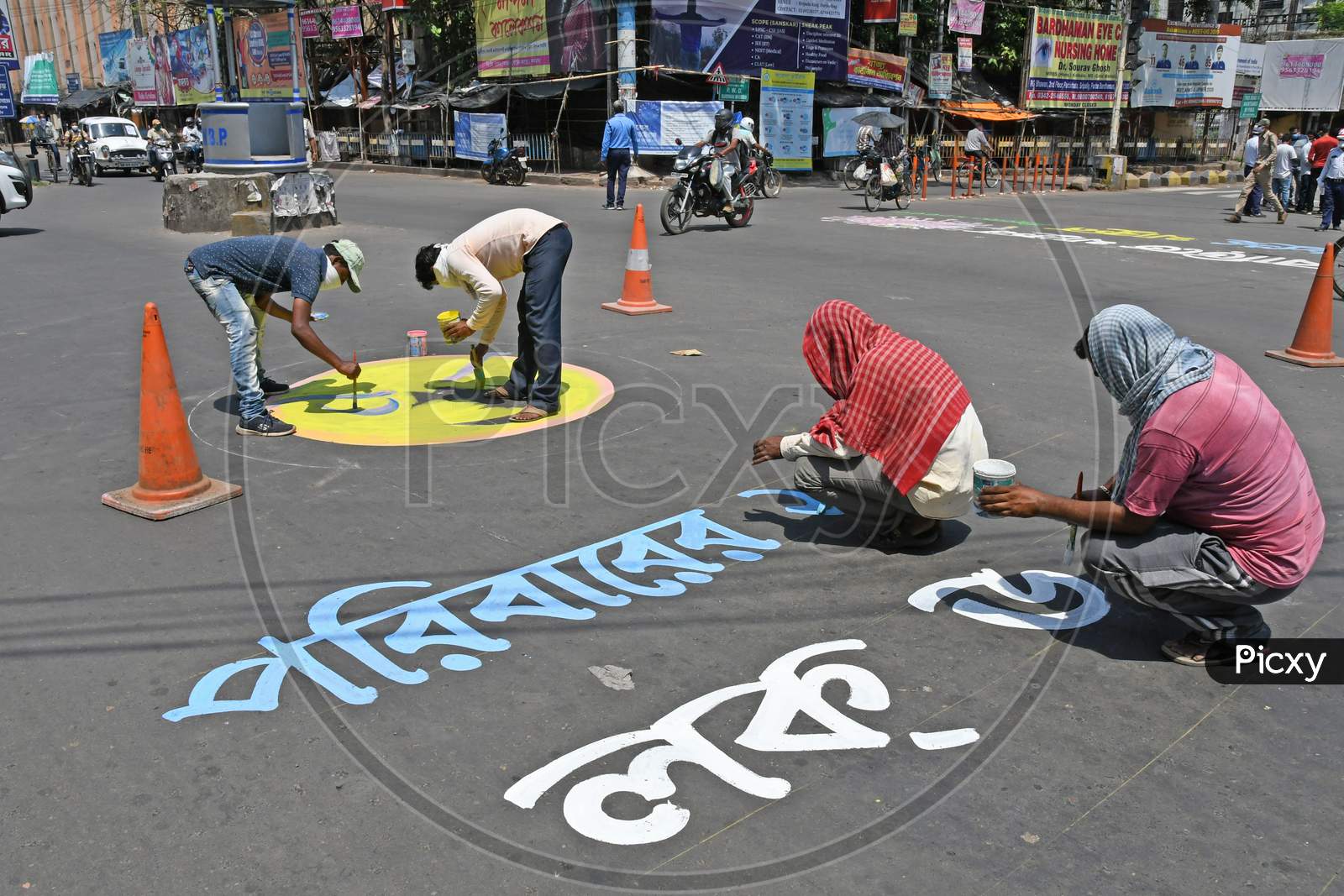 Slogans are painted on the road as part of a campaign to get people to comply with the lockdown to prevent coronavirus Covid-19. At Burdwan Town, Purba Bardhaman District, West Bengal, India.