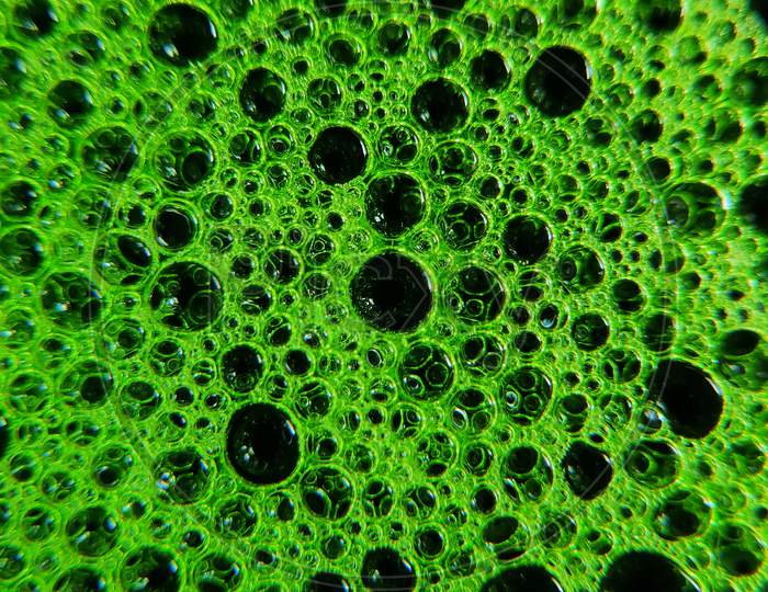 Photo of green colour bubbles on water surface. Design of water bubbles on water surface.