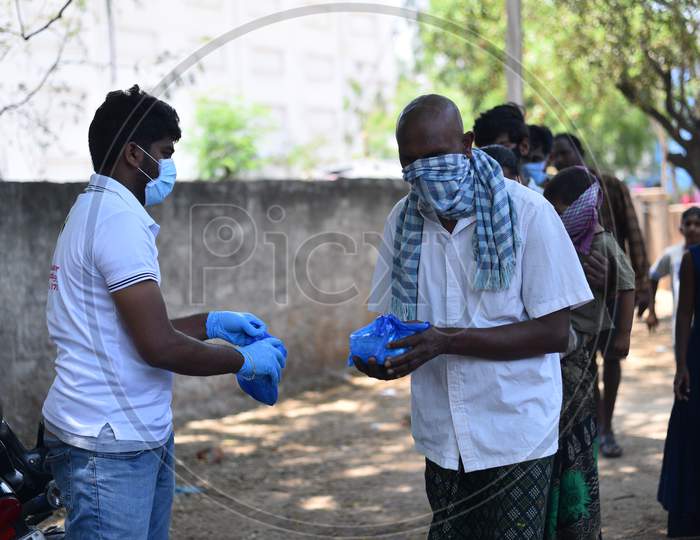 People donating food packets to the poor and migrant workers living in Hitech City area amid nationwide lockdown due to coronavirus pandemic, April 10,2020, Covid 19