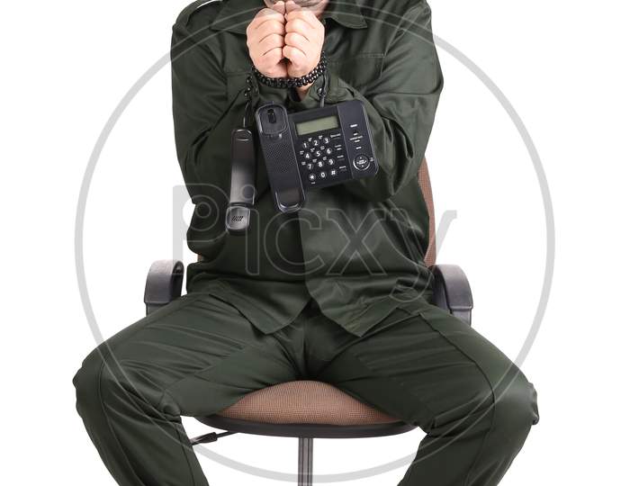 Man In Workwear Tied Up With Phone. Isolated On A White Background.