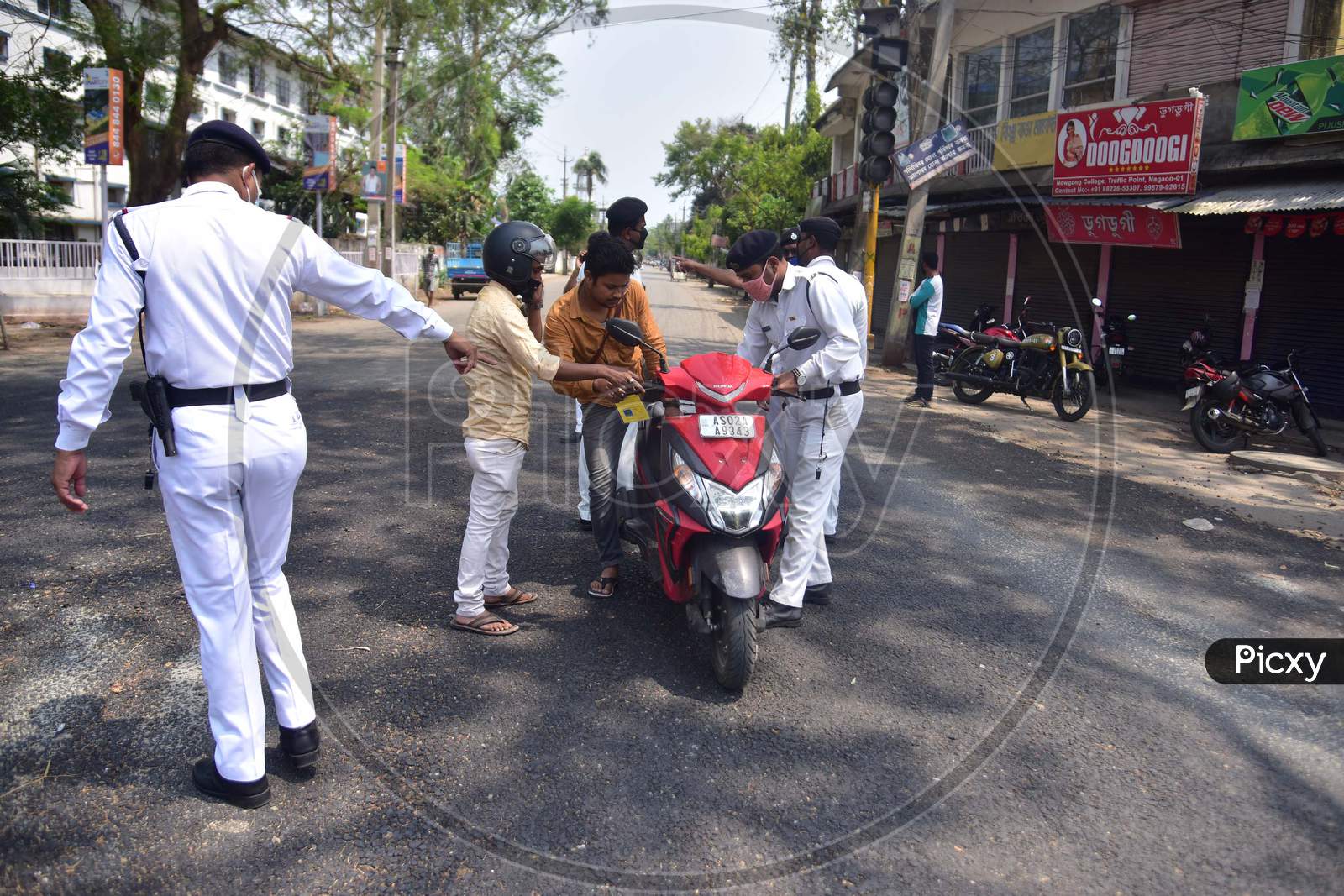 Police checking documents of commutes during a nationwide lockdown, as a preventive measure against the COVID-19 coronavirus  in Nagaon district in the northeastern state of Assam, India on April 11,2020