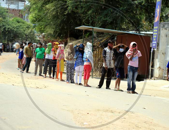People Queue To Get Free Food Packets During A Government-Imposed Nationwide Lockdown As A Preventive Measure Against The Spread Of The Covid-19 Coronavirus In Prayagraj, April, 11, 2020.