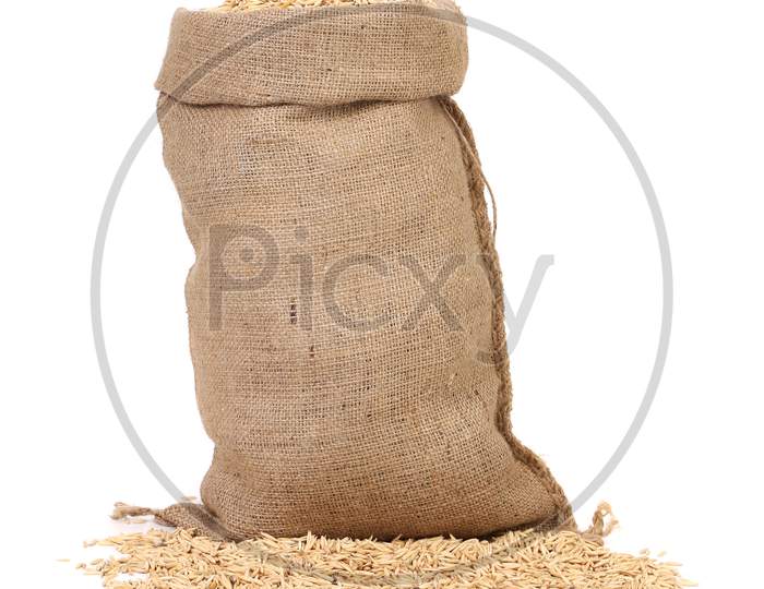 Wheat Grains In The Bag. Isolated On A White Background.