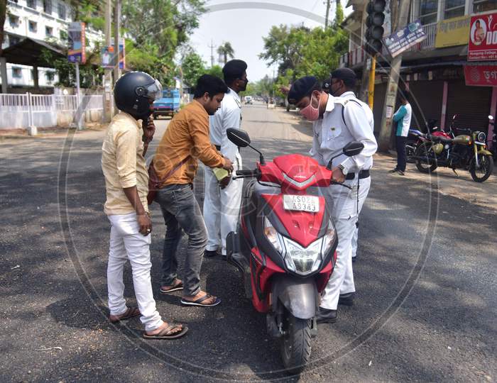 Police checking documents of commutes during a nationwide lockdown, as a preventive measure against the COVID-19 coronavirus  in Nagaon district in the northeastern state of Assam, India on April 11,2020