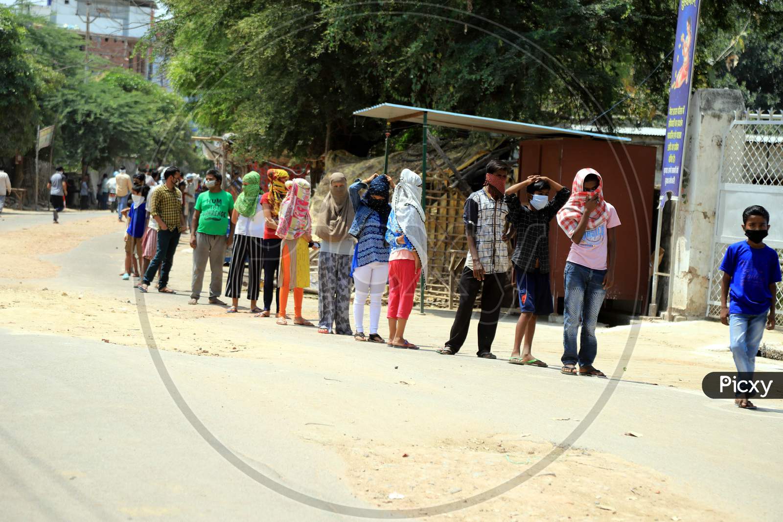 People Queue To Get Free Food Packets During A Government-Imposed Nationwide Lockdown As A Preventive Measure Against The Spread Of The Covid-19 Coronavirus In Prayagraj, April, 11, 2020.