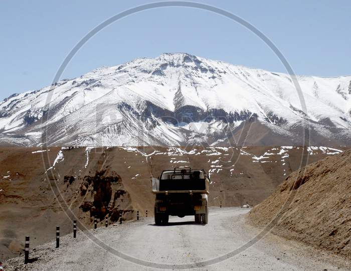 Vehicles On The Roads of Ladakh With Mountains in Background
