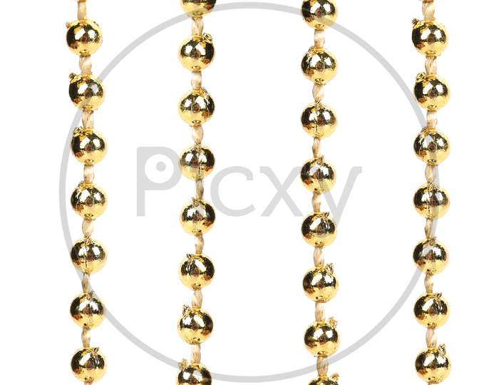 Strings Of Golden Beads. Close Up. Whole Background.