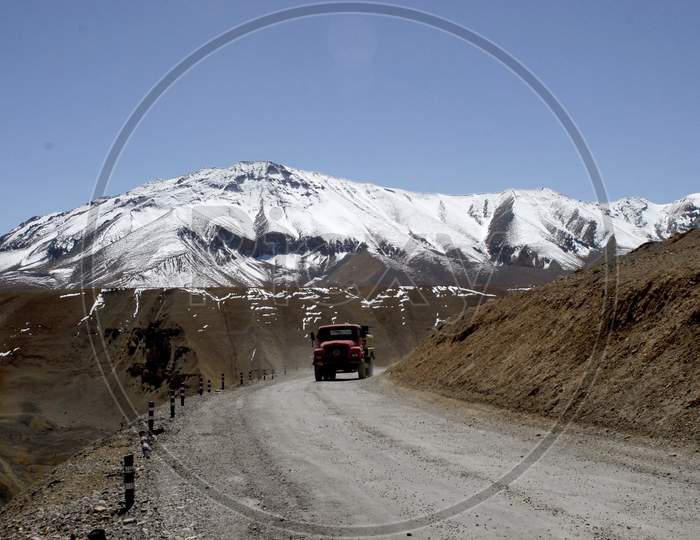 Vehicles or Trucks On The Roads Of Ladakh With Mountains in Background