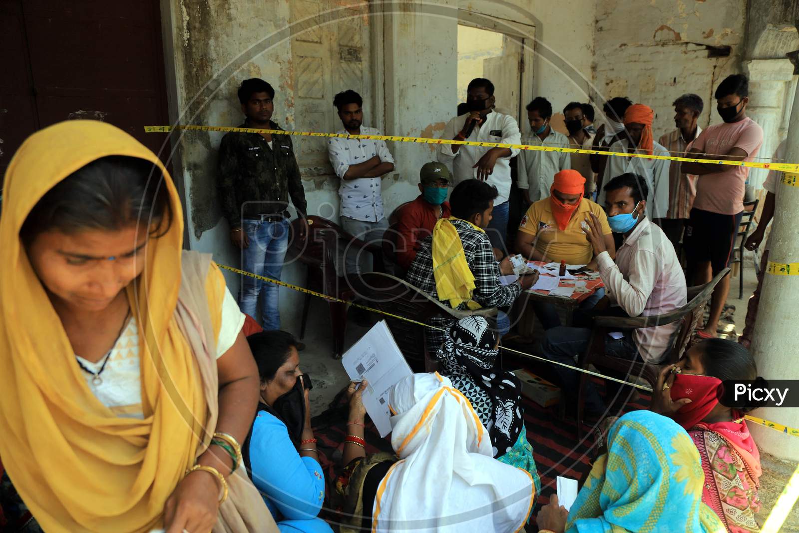 Women Waiting For Ration At A Government Ration Shop During Nationwide Lockdown In Wake Of Coronavirus Or COVID-19 Pandemic In Prayagraj, March 12, 2020.