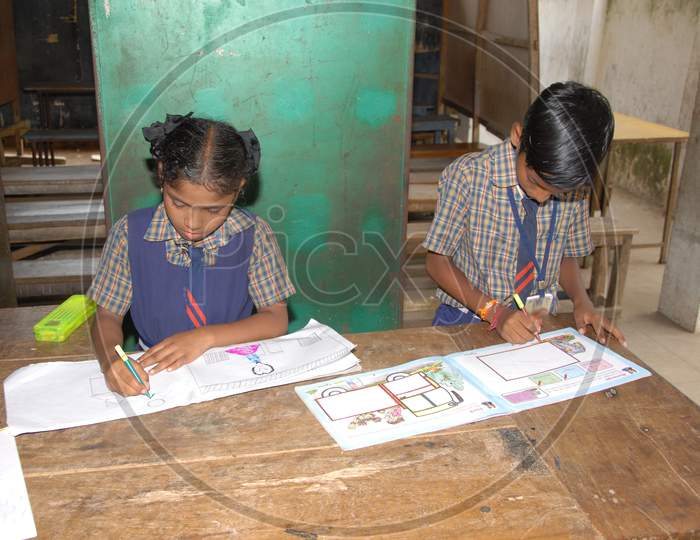 School Children Practicing  Drawing on a Painting Book in  a Classroom
