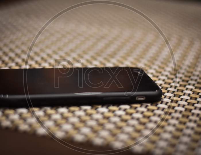 black mobile phone on the table