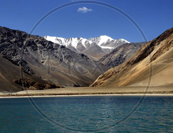 Pangong Lake With a View Of Snow Capped Mountains In Ladakh